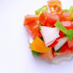 Mediterranean diet concept. Chopped tomato with onion and green peppers.