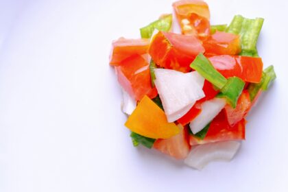 Mediterranean diet concept. Chopped tomato with onion and green peppers.
